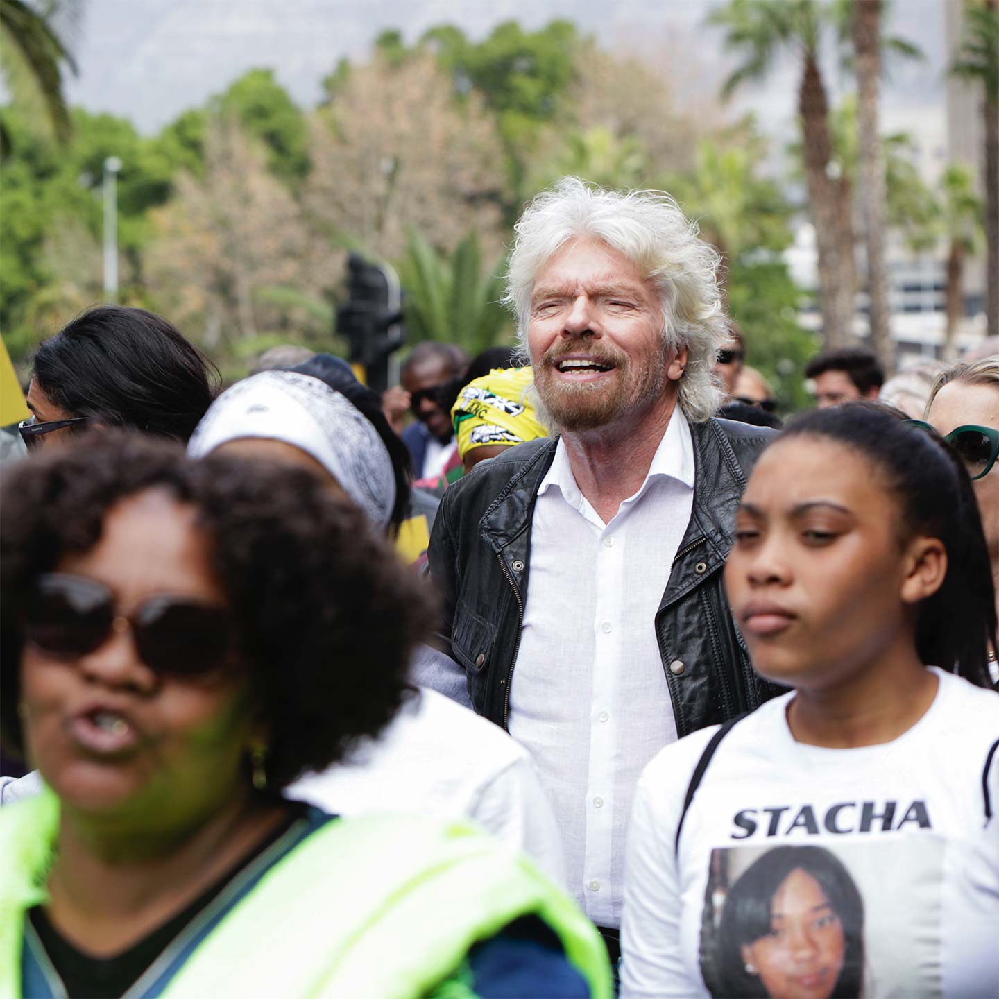 Richard Branson marching in a crowd at an Elders event